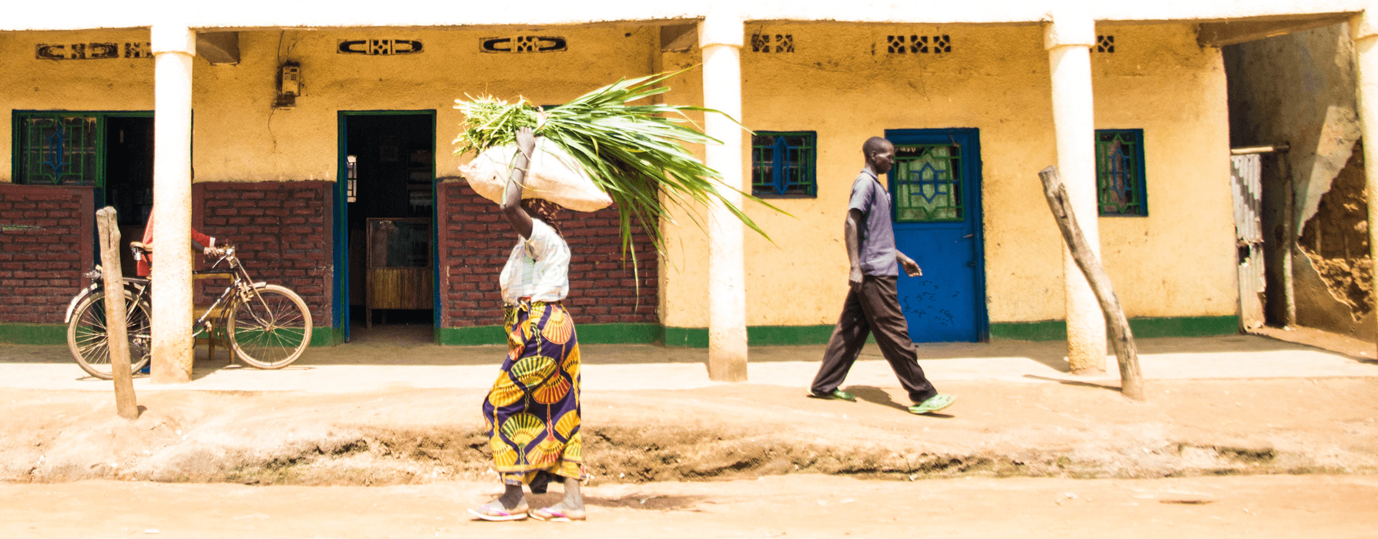 Cooperative Members Walking Down The Street In Rwanda