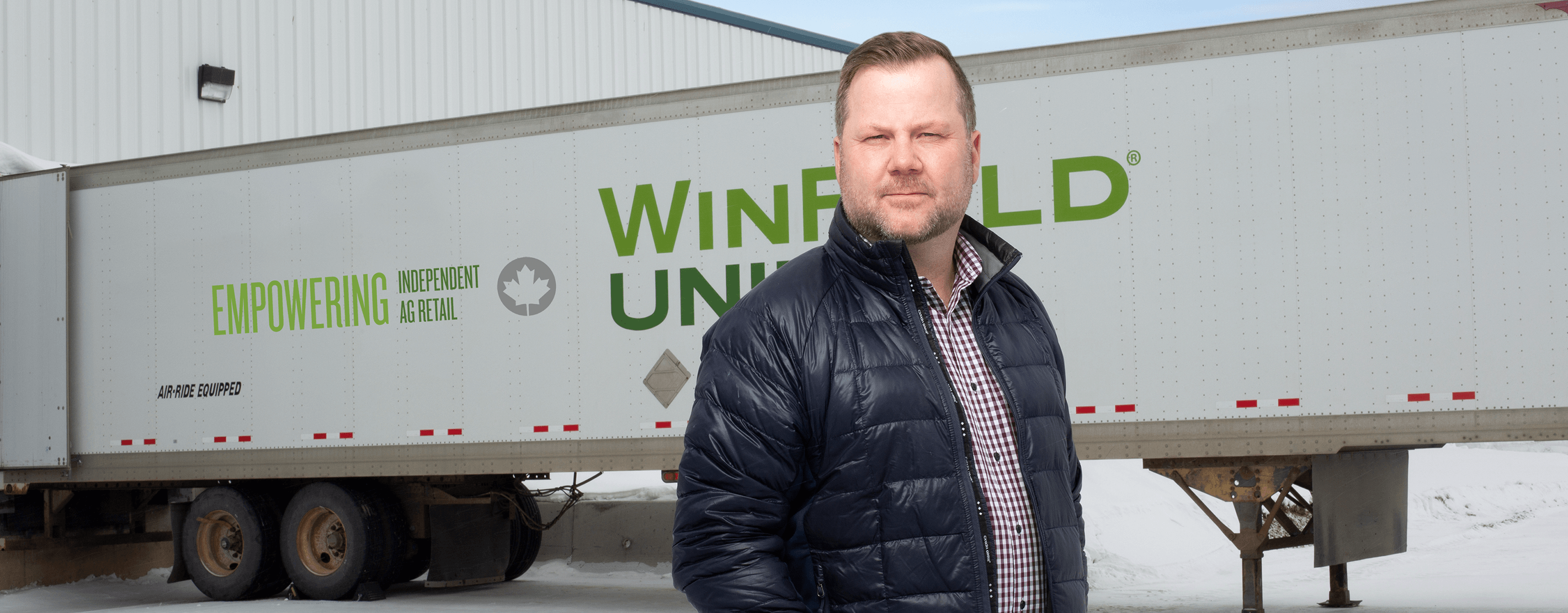 Greg McDonald Standing Next To A WinField United Truck
