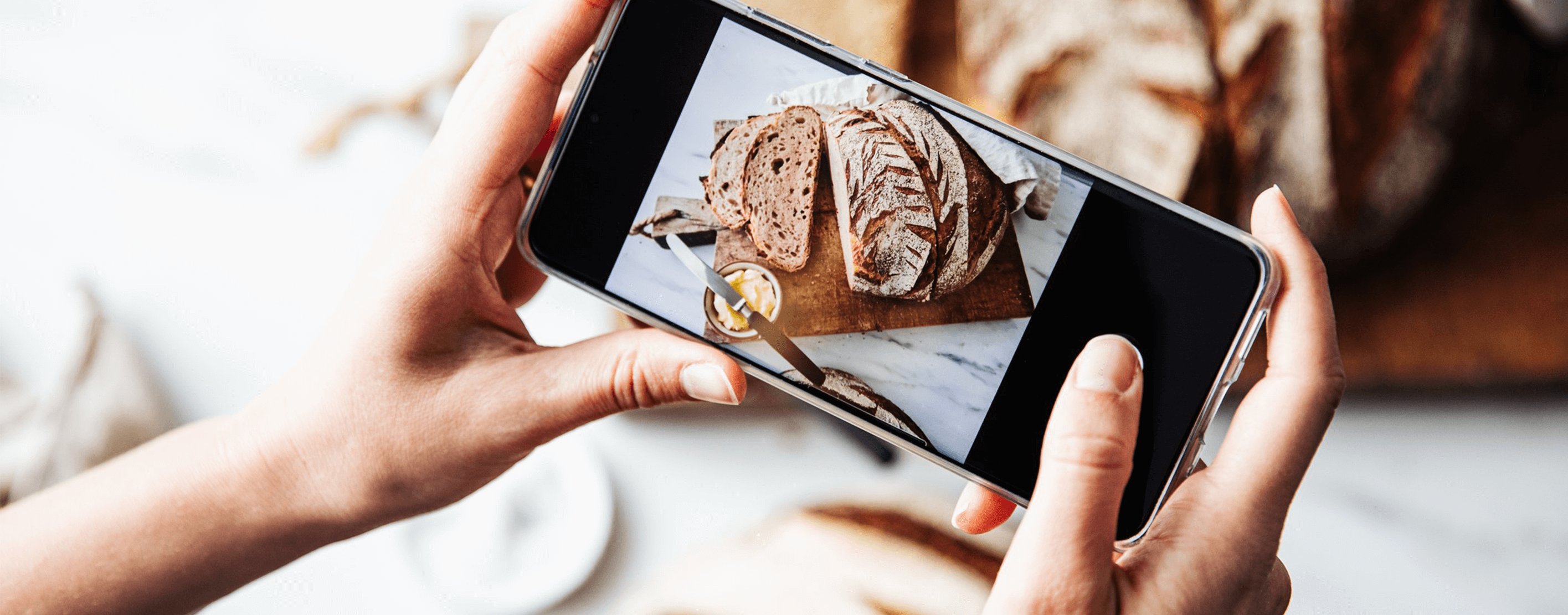 A Person Taking A Picture Of Freshly Baked Bread