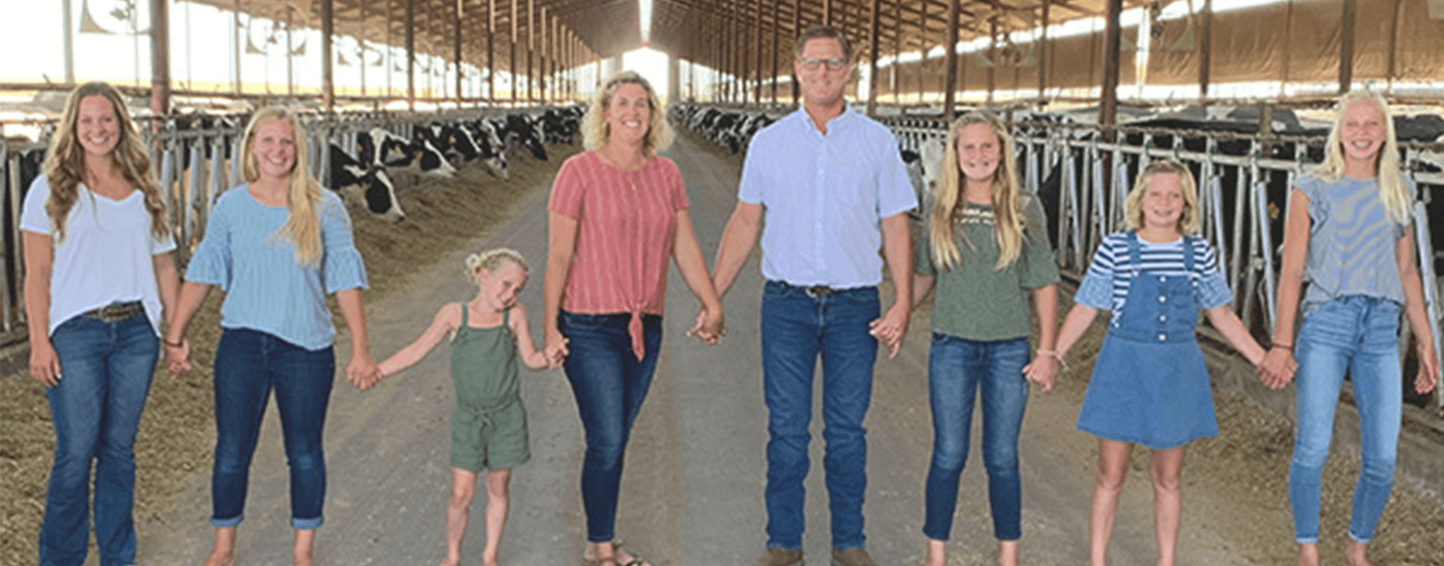 A Family Of Famers Together In A Barn