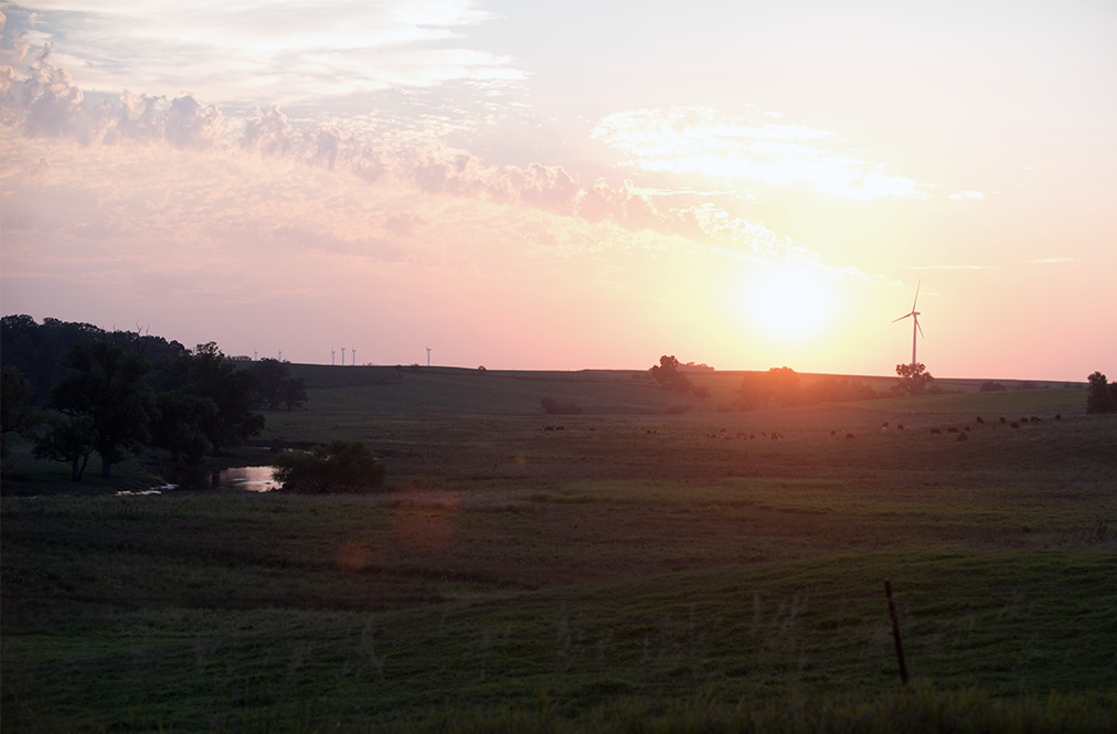 A View Of A Farm Field At Sunset