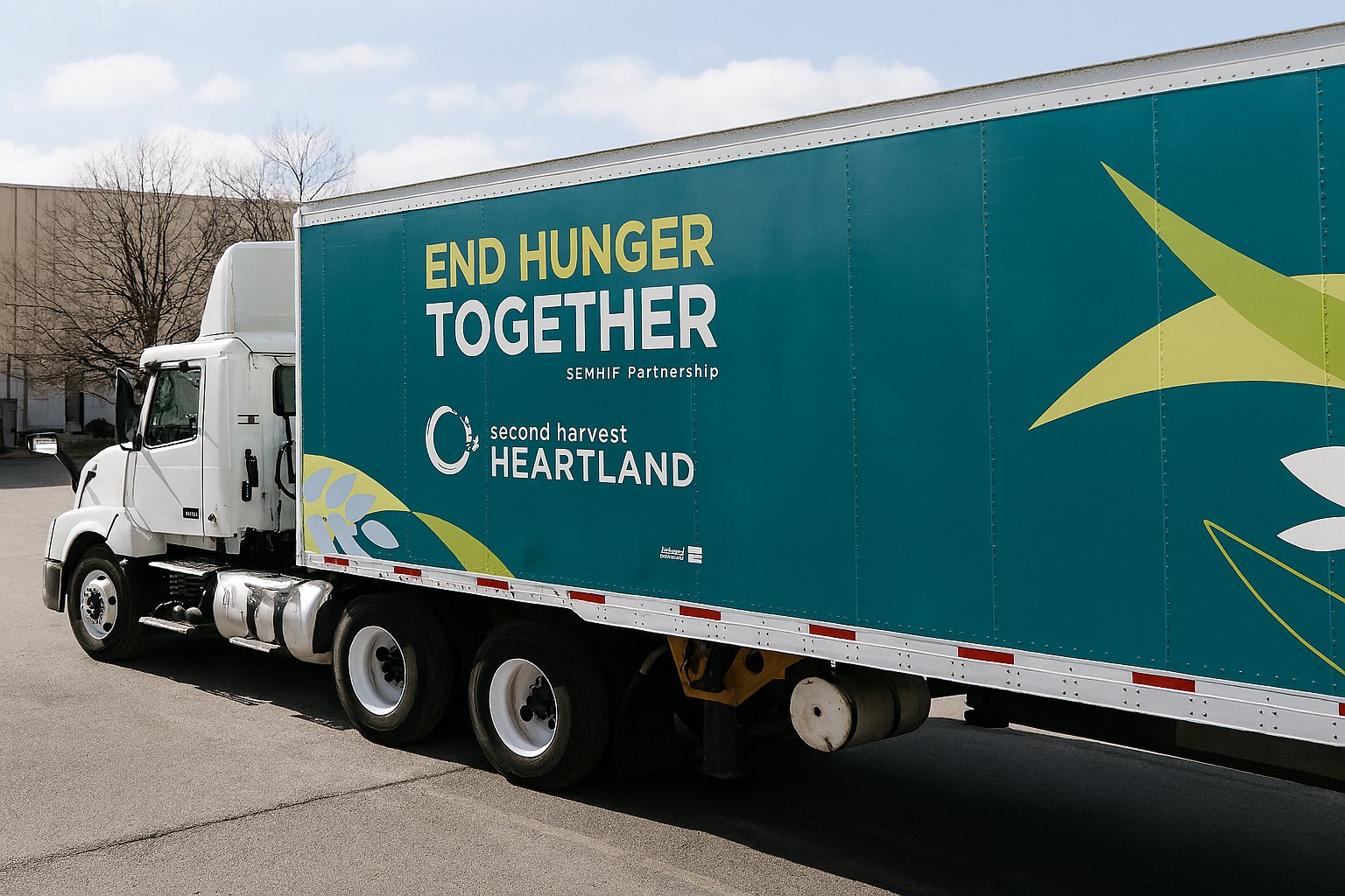 A semi truck from Second Harvest Heartland backs up to a loading dock to make a delivery.