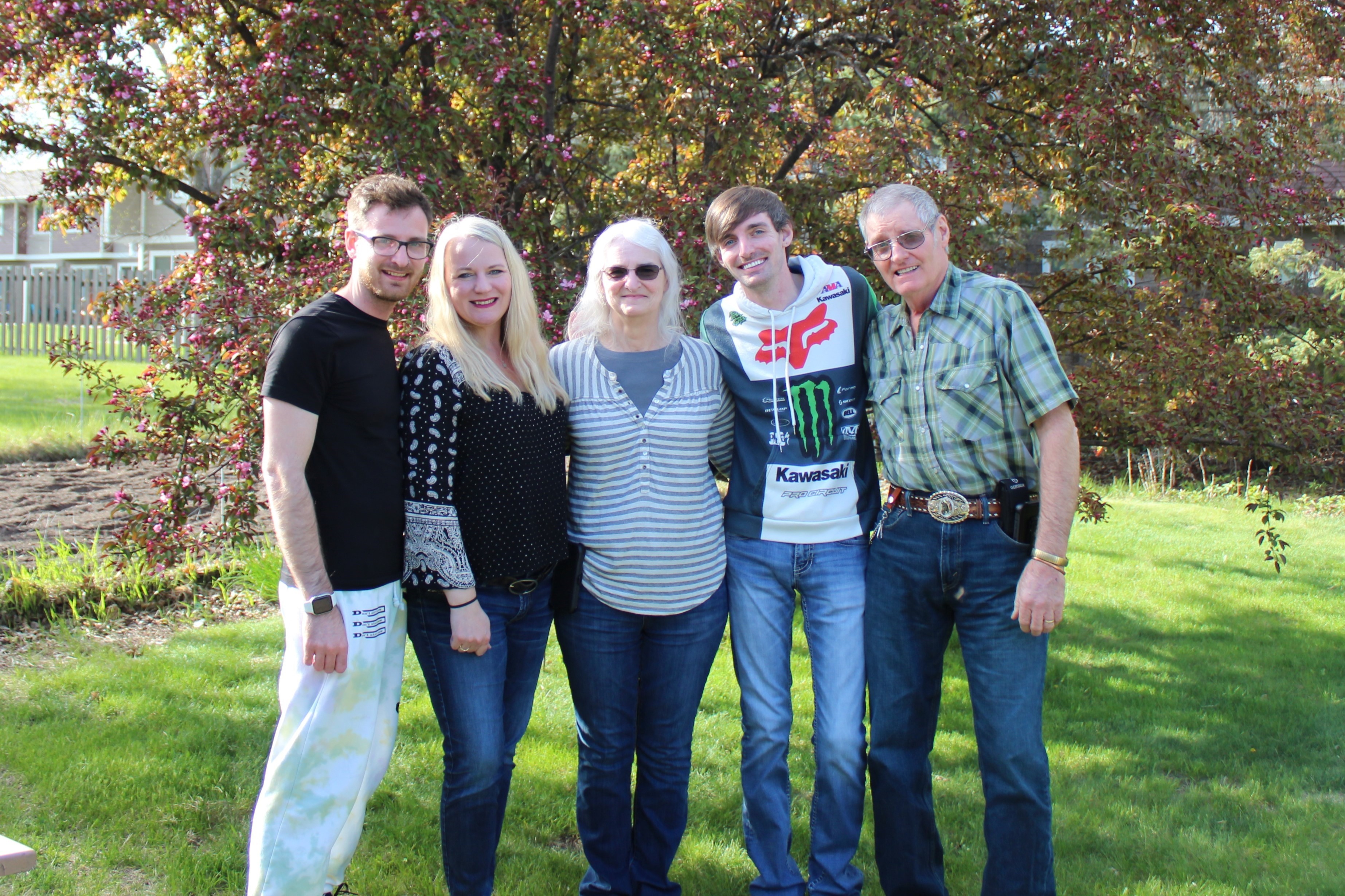 Sue Tesch and her family pose for an outdoor photo.