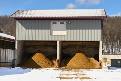 Covered storage bays holding animal feed.
