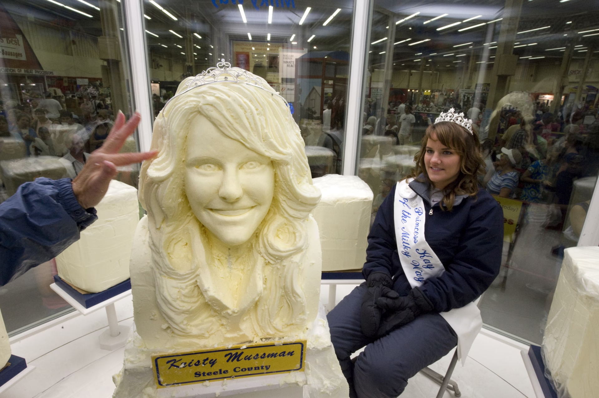 Princess Kay of the Milky Way sits beside her likeness carved from a block of butter at the Minnesota State Fair.