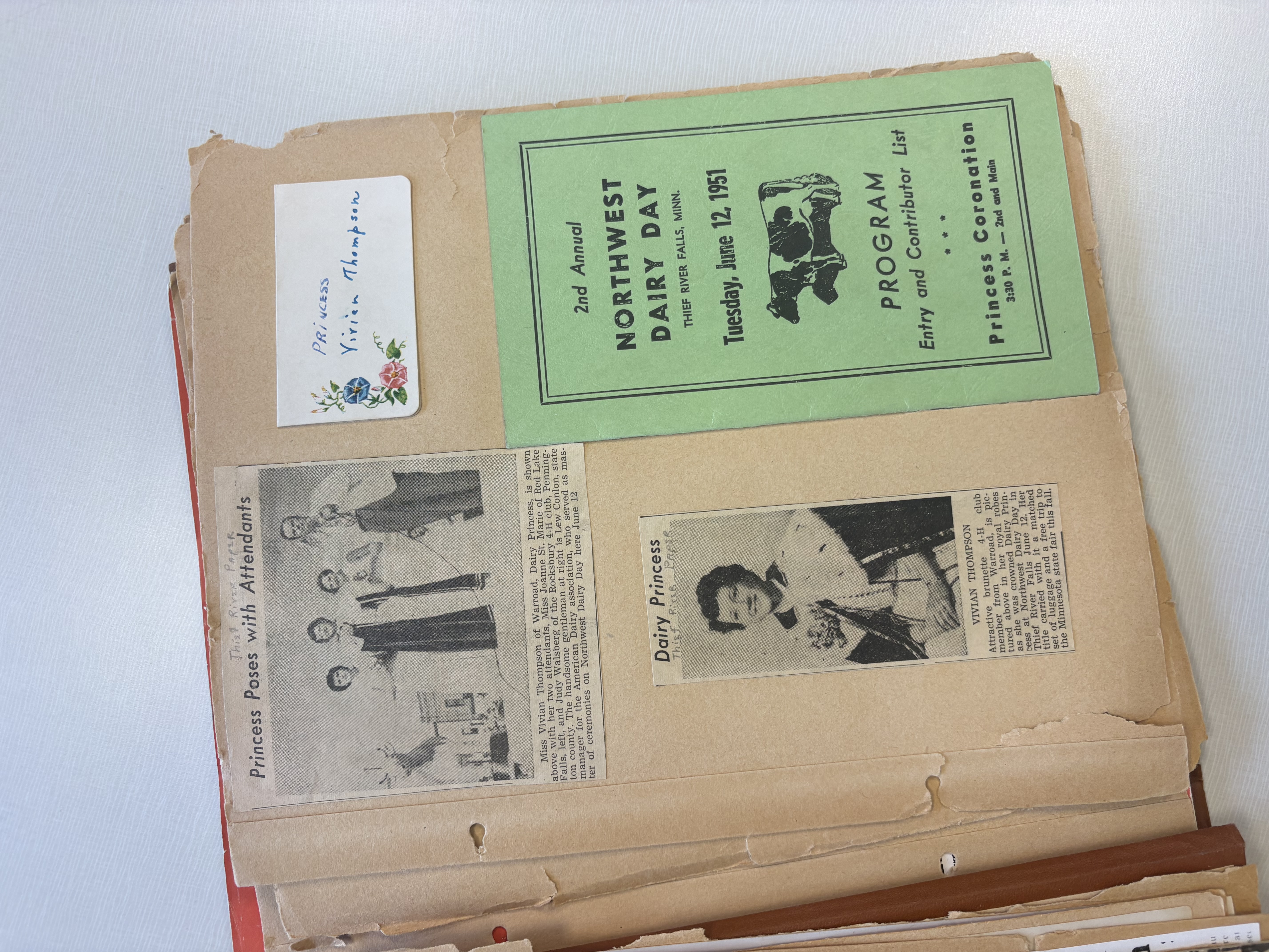 Scrapbook page featuring 1951 Dairy Princess Vivian Thompson newspaper clippings, event memorabilia and a Northwest Dairy Day program.