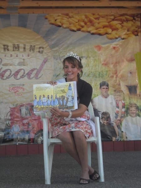Princess Kay of the Milky Way reads to children at a community event.