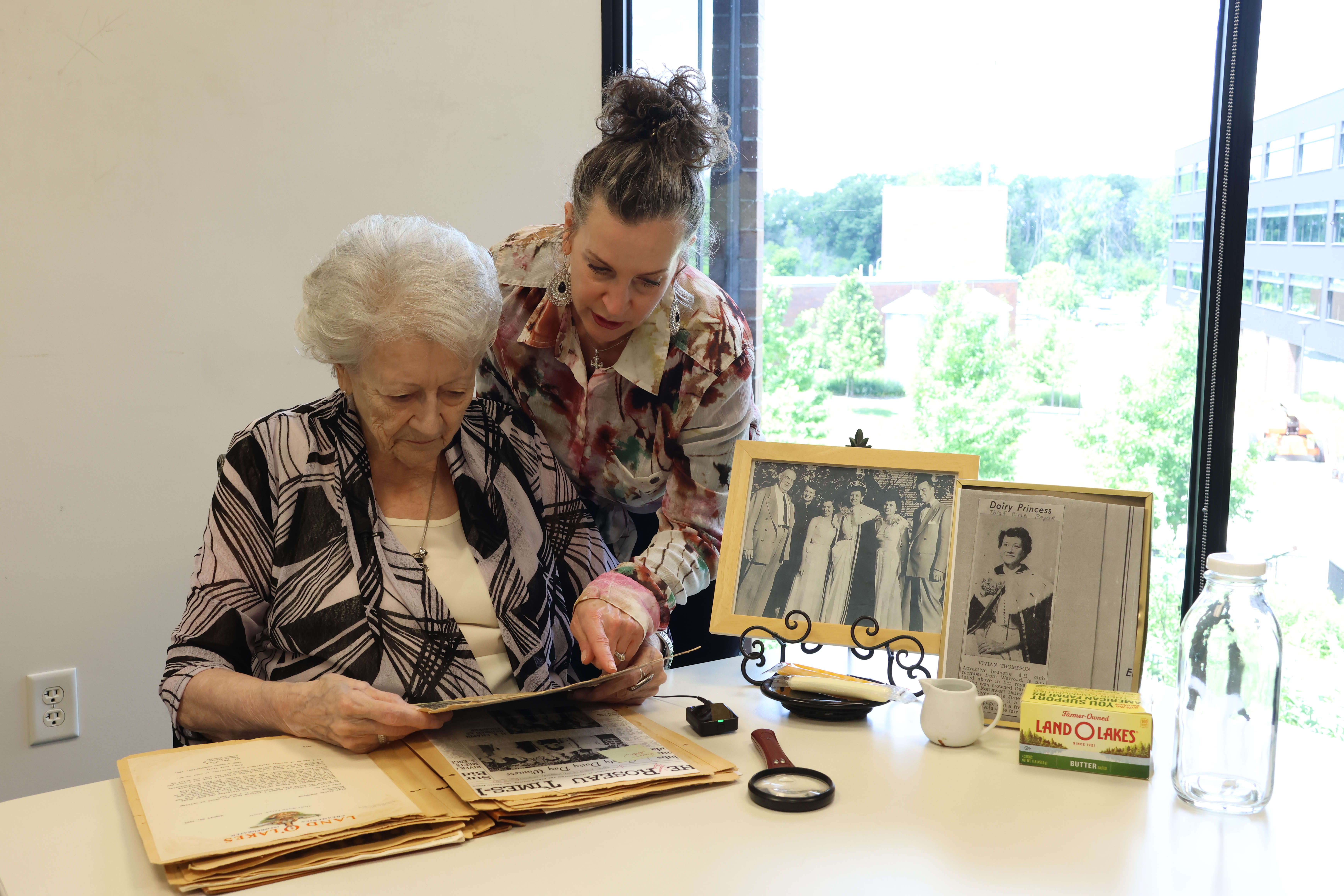 Reviewing dairy princess memorabilia and newspaper clippings from 1951.