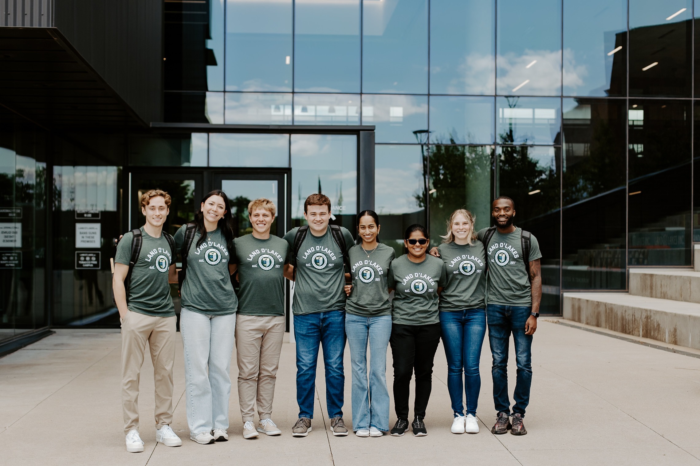 A group of interns pose for a photo in front of Land O'Lakes.