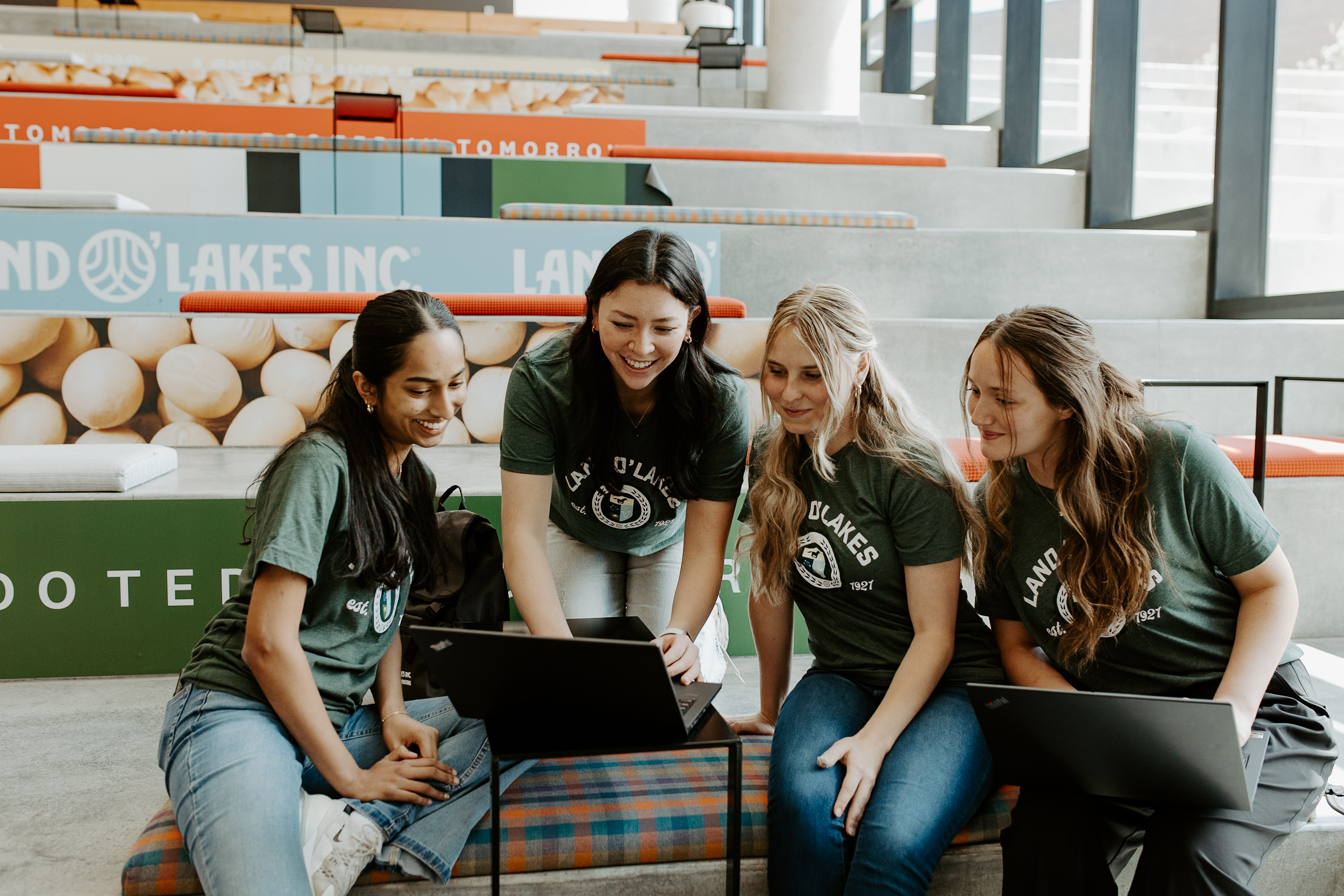 A group of interns are hanging out on a set of large stairs.
