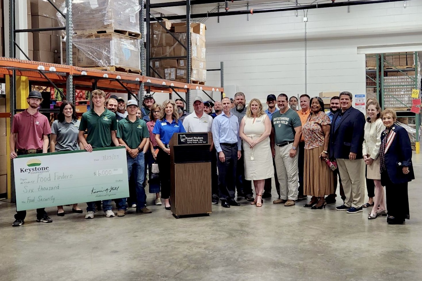 A group of people at a food bank posing for a photo.