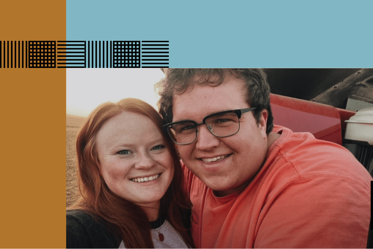A young farming couple pose together for a photo